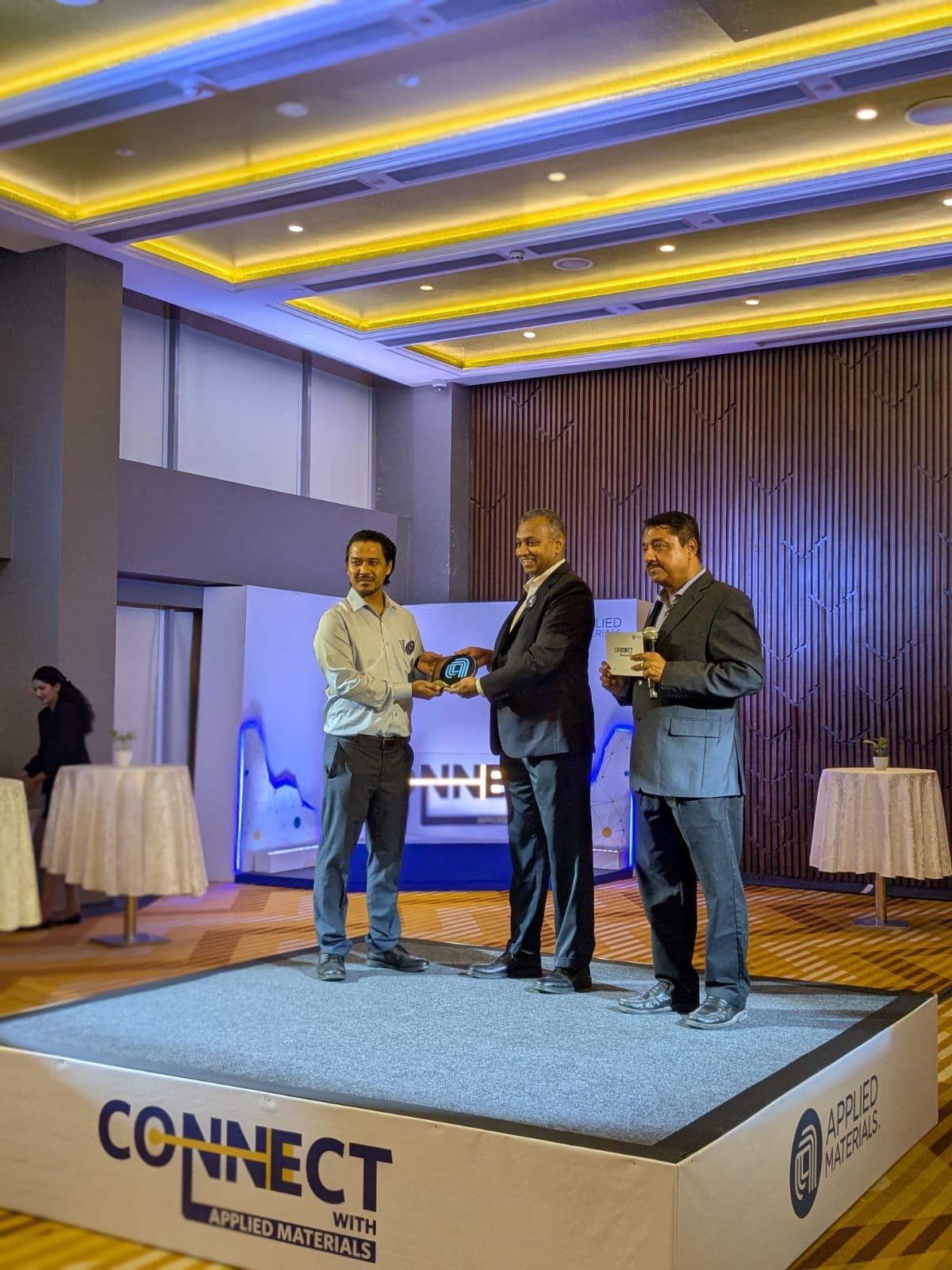 Receiving an award at the CONNECT with Applied Materials event, 2025.